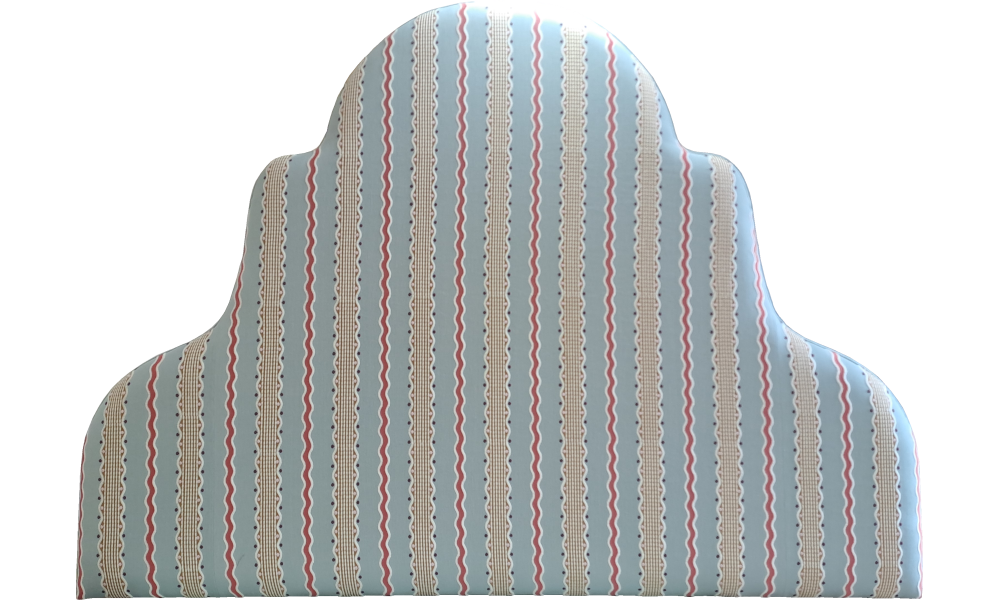 A shaped headboard with a sky blue fabric embroidered with red and gold striped.