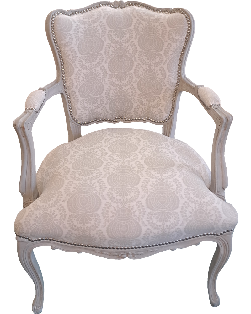A French antique chair in a French fabric and pewter studs.